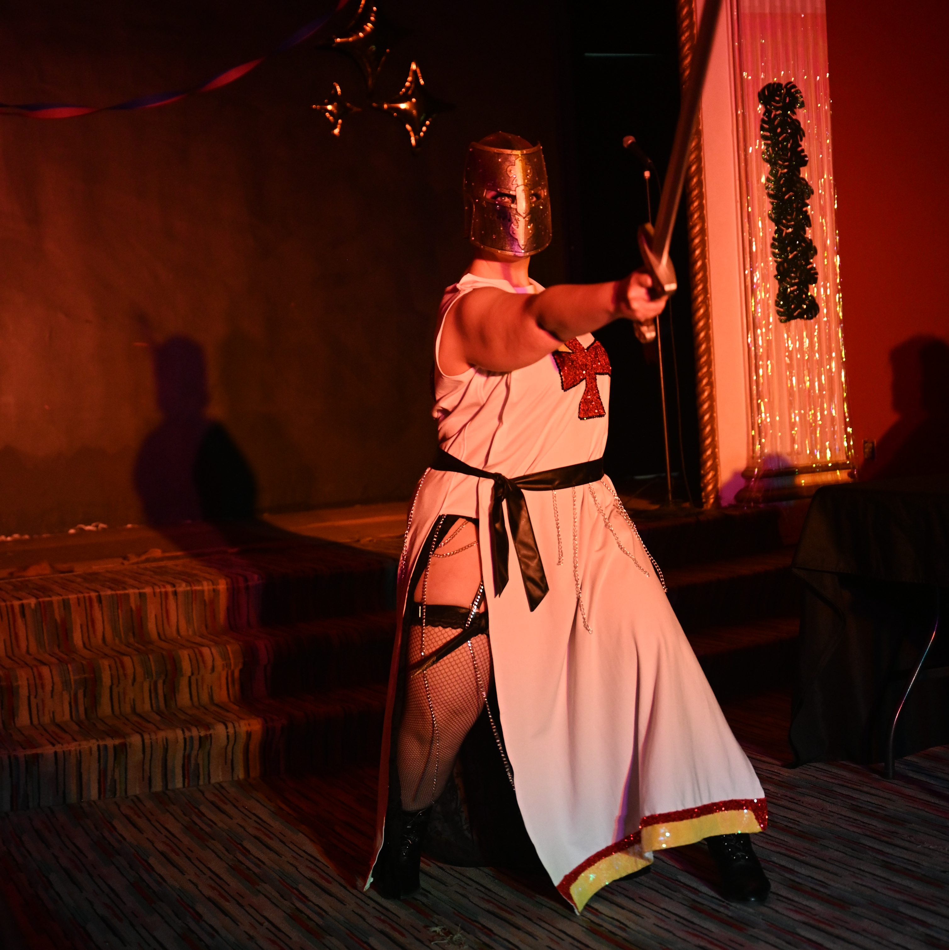 Ostara points her sword at the audience
